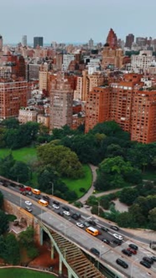 Lush greenery on both sides of busy highway on the waterfront of Hudson River.