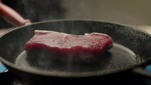 Close Up of Steak Frying in Pan