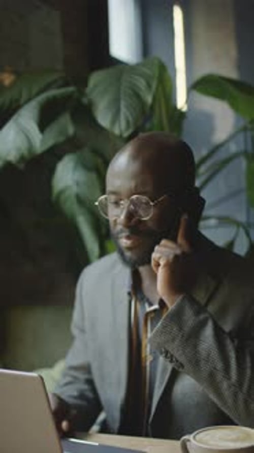 Businessman Talking on Phone at Office Desk