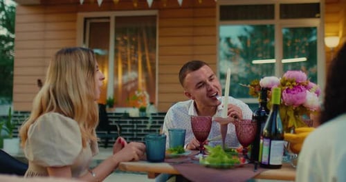 Friends Gather Outside for Dinner and Conversation