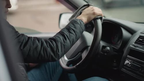 Side View of Road Traveler Wiping Steering Wheel with Towel