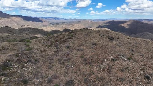 Aerial view of rugged mountains under blue sky, United States.
