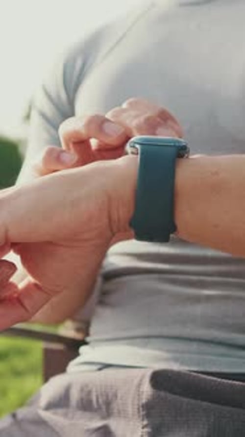 Close-up of unrecognizable young man's hands using smart watch