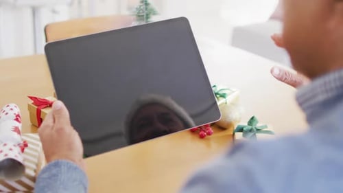 Man Video Calling at Christmas with Tablet