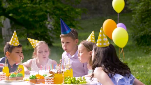 Children Celebrate Birthday with Cake and Balloons Outdoors