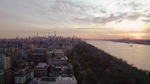 Serene drone shot of Manhattan buildings and Hudson River at sunset