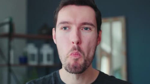 Young caucasian man bites into burger, burger eating pleasure, close up portrait fast food eating, u