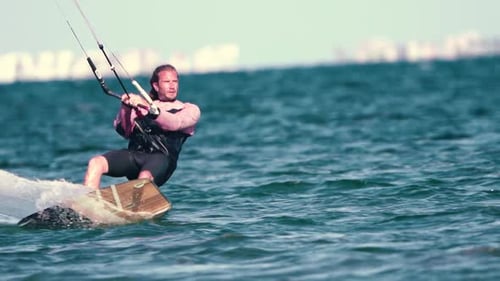 Sportsman practicing kite surf sport at the beach on a windy day at the Spanish coasts