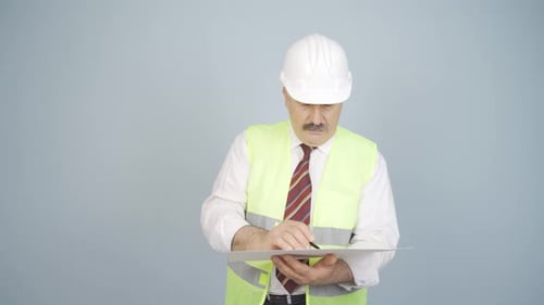 The engineer examines the project in his hands.