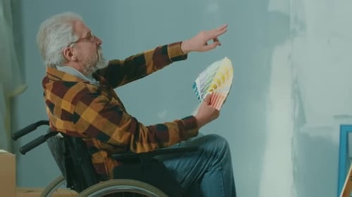Senior Man in Wheelchair Choosing Paint Colors