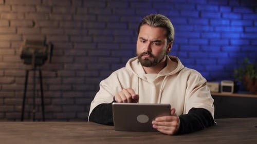 Producer Using Digital Tablet for Work at Recording Studio