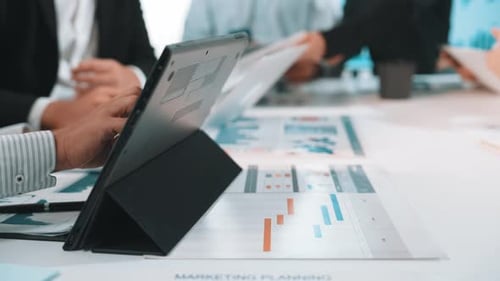 Business Meeting: Team Discusses Marketing Strategy with Tablet