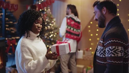 Woman Receives Christmas Gift and Hug from Man