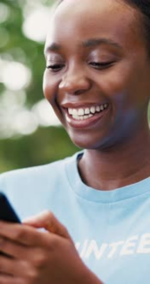 Volunteer, cellphone and black woman in park, funny and program for donation, smile and email