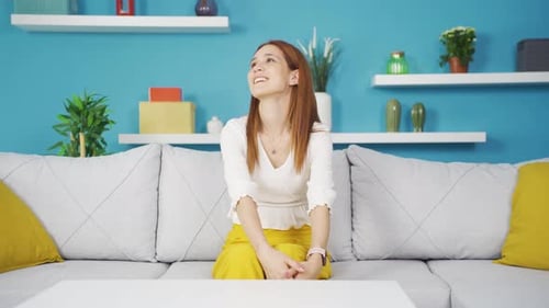 Cheerful Woman Smiling on Sofa Indoors