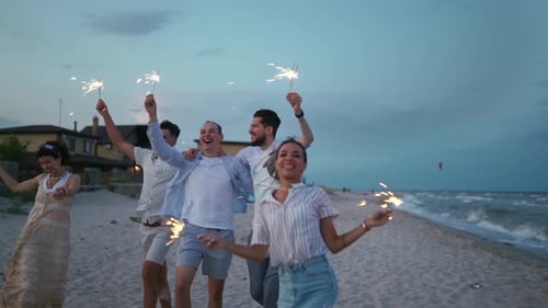 Friends Celebrating with Sparklers on the Beach