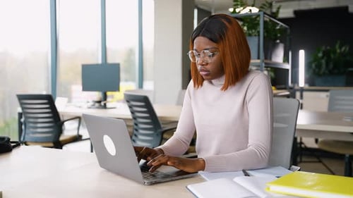African American Student Working on Laptop in Library