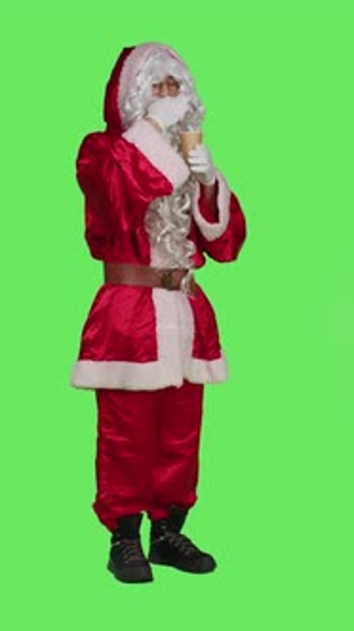 Vertical Video Side View of Santa Claus Drinks Cup of Hot Chocolate