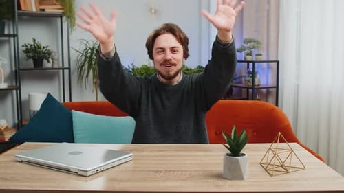 Man Waving and Smiling at Camera Indoors