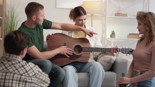 Friends Play Guitar Together in Living Room