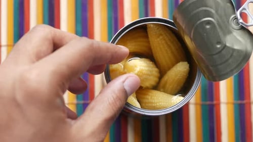Opening Can of Baby Corn Revealing Vegetables