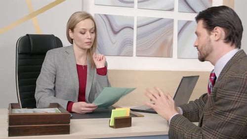 Portrait of Serious Woman HR Director Interviewing Male Job Seeker at Office