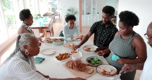 Multigenerational Family Serving and Eating Dinner at Kitchen Island 1617 Years