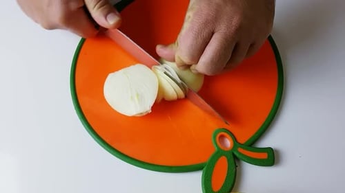 Slicing an Onion on a Cutting Board