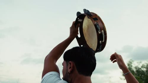 Tambourine Player Playing Over His Head