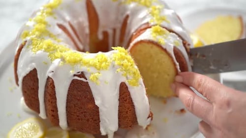 Time Lapse Step By Step Slicing Lemon Bundt Cake Decorated with Lemon Zest on a Cake Stand
