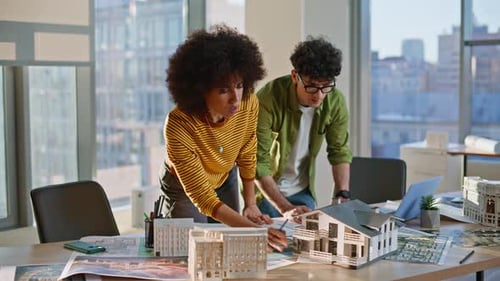 Property Managers Working Building Layout at Office Desk Two Contractors