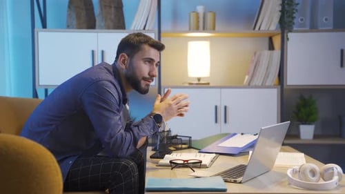Young Adult Working Late At Night On Laptop