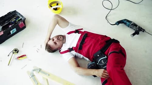 Injured Construction Worker Lying on Floor After Accident