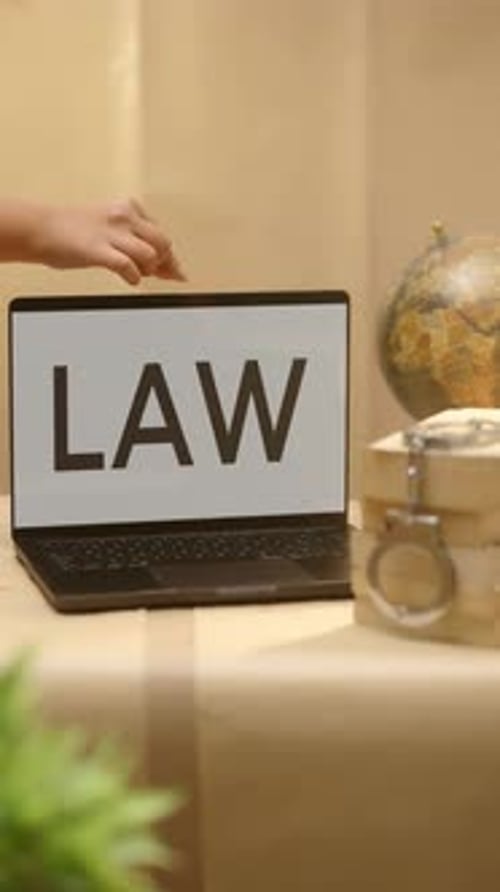 Laptop Screen Displaying Word Law With Globe