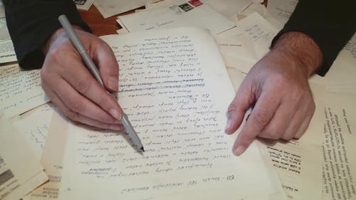 Man Checking Documents And Signing It Using A Pen On The Office Table. Hands Writing On Paper. - clo