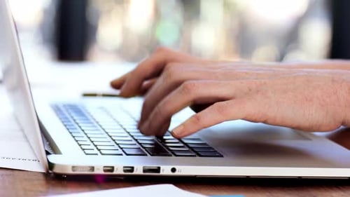 Typing on Silver Laptop in Office Close Up