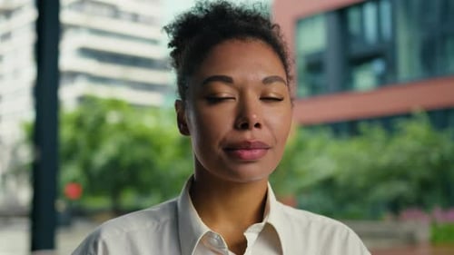 Confident Young Woman Smiling in Urban Setting