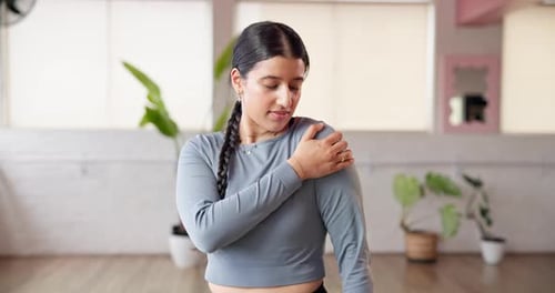 Pilates, shoulder pain and sprain with woman in studio for joint injury