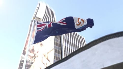 Realistic Anguilla Flag Waving on Flagpole with Modern City Buildings