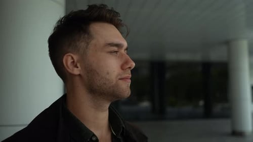 Handsome Young Man Drinks Coffee Outside Urban Building