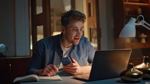 Man Video Calling on Laptop and Mobile at Night
