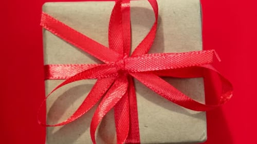 Close Up Rotation of Gift Box on Red Background