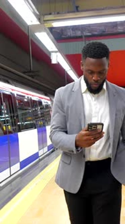 Manager Walking and Using Smartphone in Subway Station