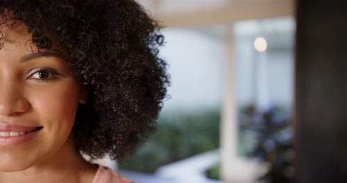 Smiling woman with curly hair enjoying her day, close-up portrait, copy space