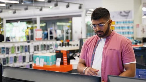 Indian Man at Tech Store Looking for a New Smart TV on Black Friday