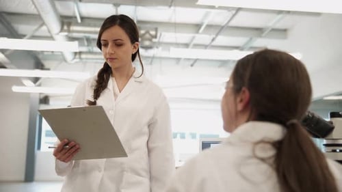 Scientists in Lab Coats Discussing Research Findings