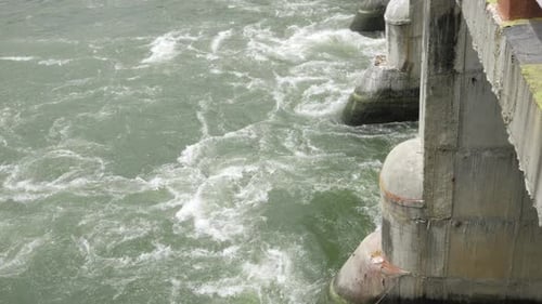 Calm Waters Meets Concrete - A Serenity-Filled View of the Ocean Waves Cresting Against a Seawall