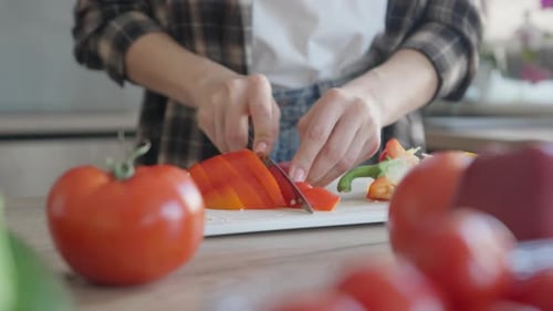 Woman Cutting Red Bell Pepper for Healthy Meal