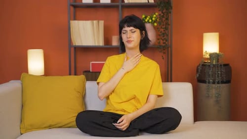 Young woman with sore throat.