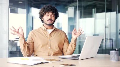 Man Meditating at Desk in Modern Office